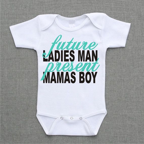 A white baby onesie with blue and black text that reads "Future Ladies Man, Present Mamas Boy."